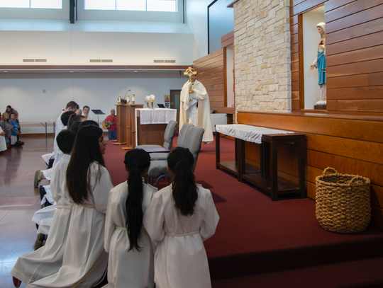 Fr. Garza blesses mass attendees with the monstance during Corpus Christi