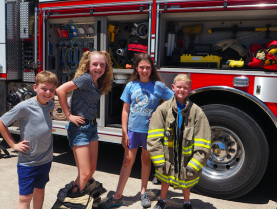 Local children Joey, Abby, Morgan and William had fun learning about firefighting equipment.