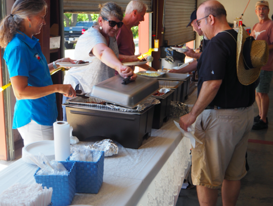 Dripping Springs Cook-Off members not only donated and cooked the BBQ, they also manned the chow line. Forefront DSCO member Michele Ryon works the serving line.