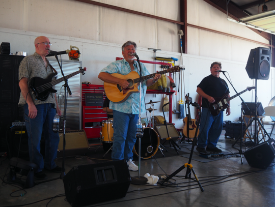 Local musical group “Silver and Gold,” donated their talent to the event. (From left to right) Jeff King (bass), Mark Dotson (guitar), Randall Maxwell (drums), and Frank Iarossi (guitar).