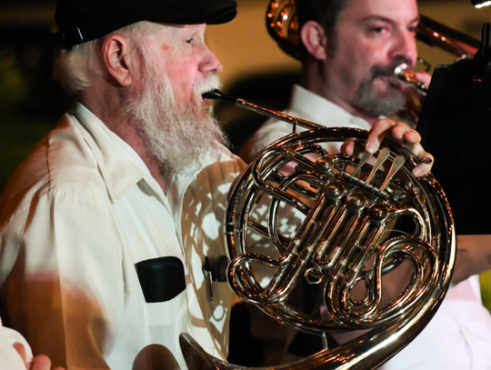 John Prickett played the French Horn. He also arranged the scores for the whole orchestra. In the back, Jonathan Mudge plays the trombone.