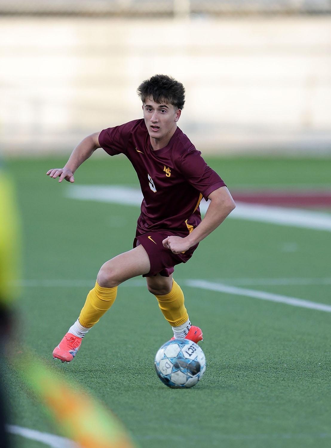 PHOTO BY VINCE CURLETTA Trey Gonczeruk (#9) keeps the ball from going out of...