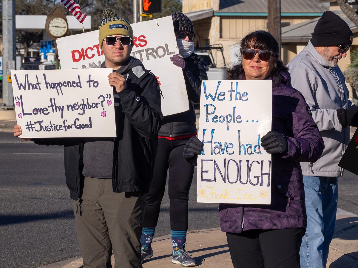 PHOTO BY DAVE WILSON Protesters hold their signs in Dripping Springs.