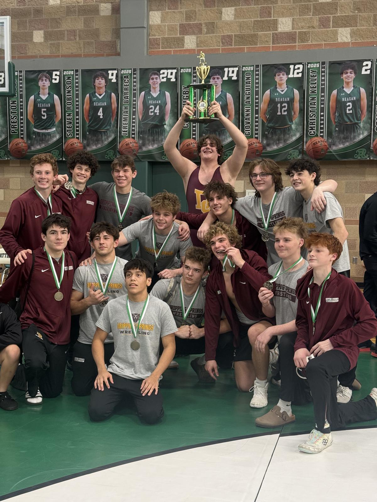 CONTRIBUTED PHOTO The boys take a victory at the Gillespie Duals, with a win...