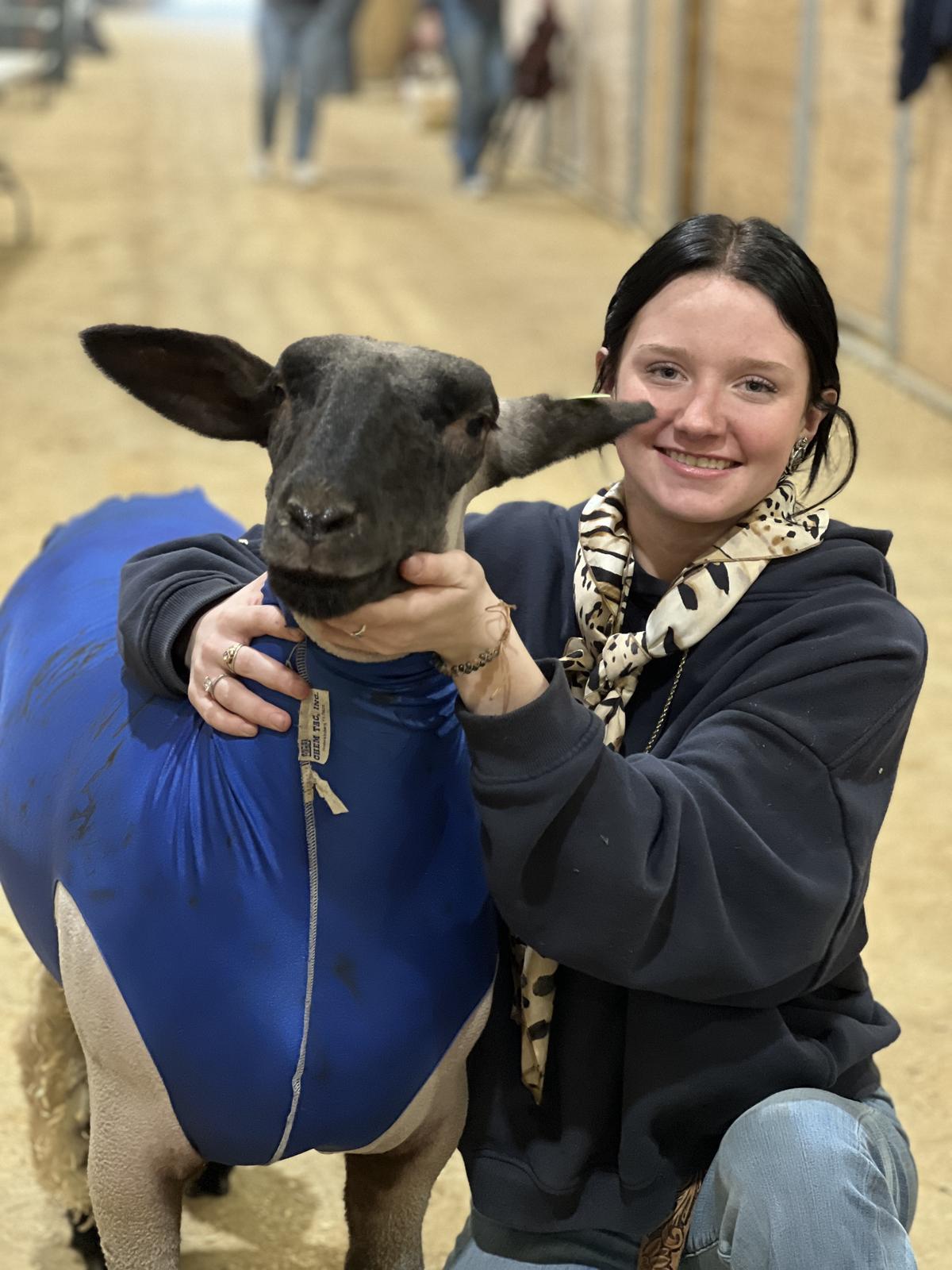 PHOTO BY LAURIE ANDERSON Lily Naumann of Buda gets her sheep ready for compet...