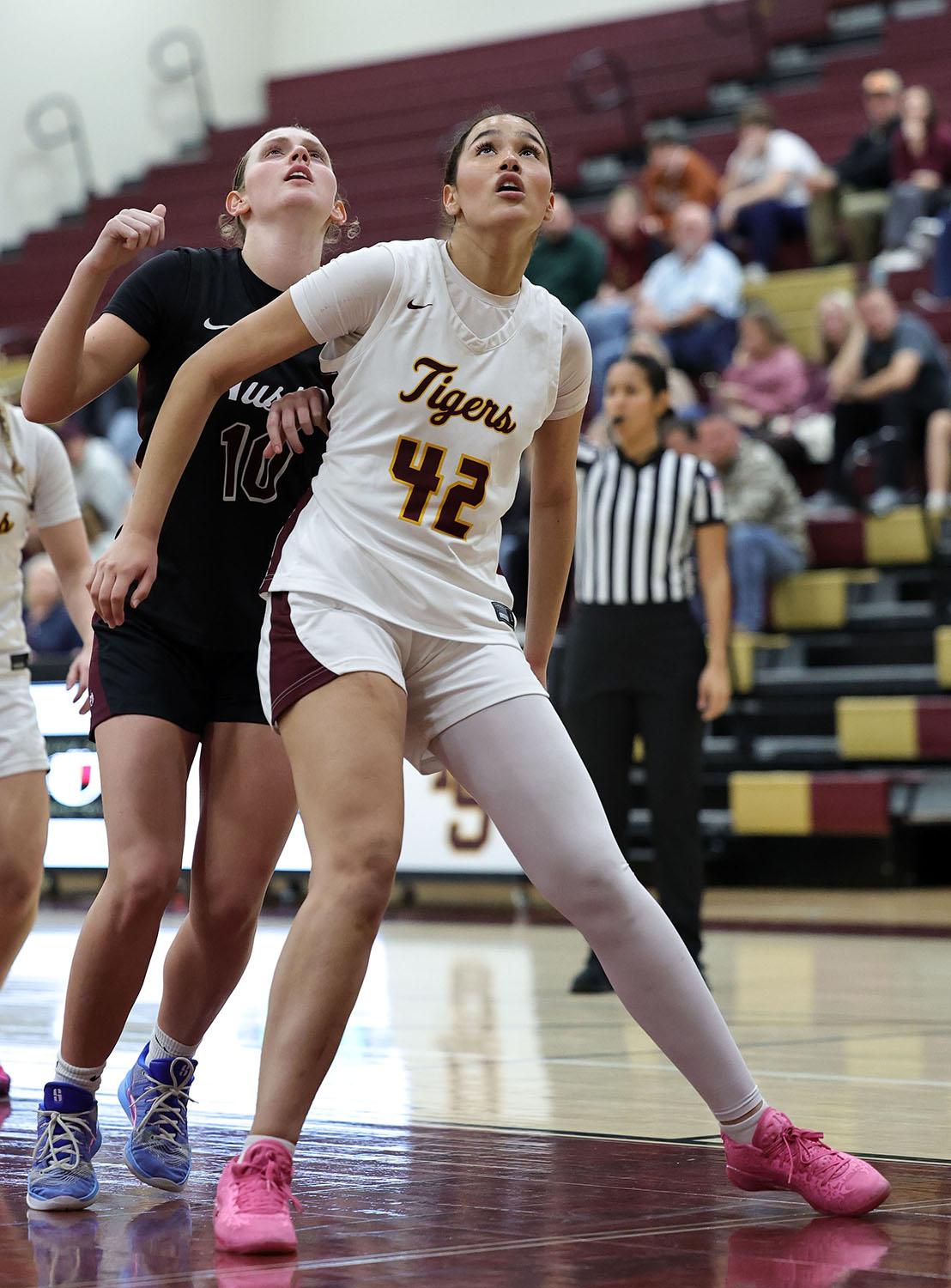 PHOTO BY VINCE CURLETTA Bailey Rogers (#42) blocks an Austin player while wai...