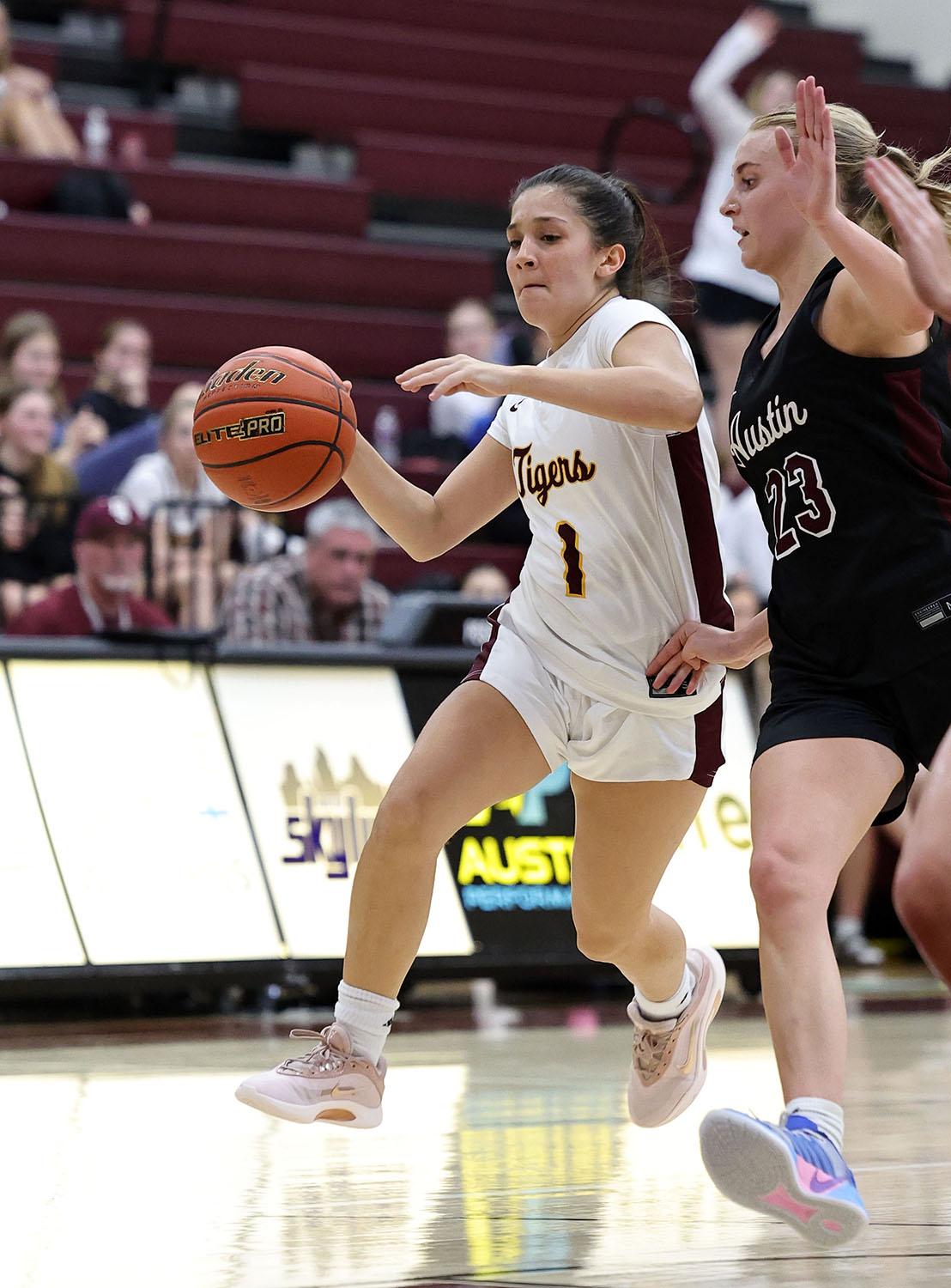 PHOTO BY VINCE CURLETTA Avery Taylor (#1) moves around an Austin defender in...