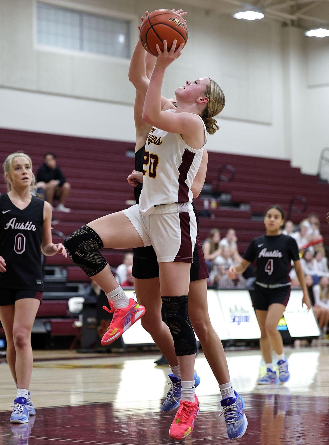 PHOTO BY VINCE CURLETTA Lily Aleshire (#20) shoots a layup against Austin in...