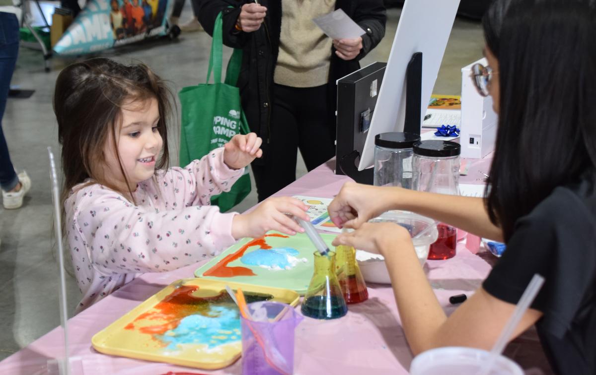 PHOTO BY LAURIE ANDERSON At the Kids Chem Cook booth, kids could participate...