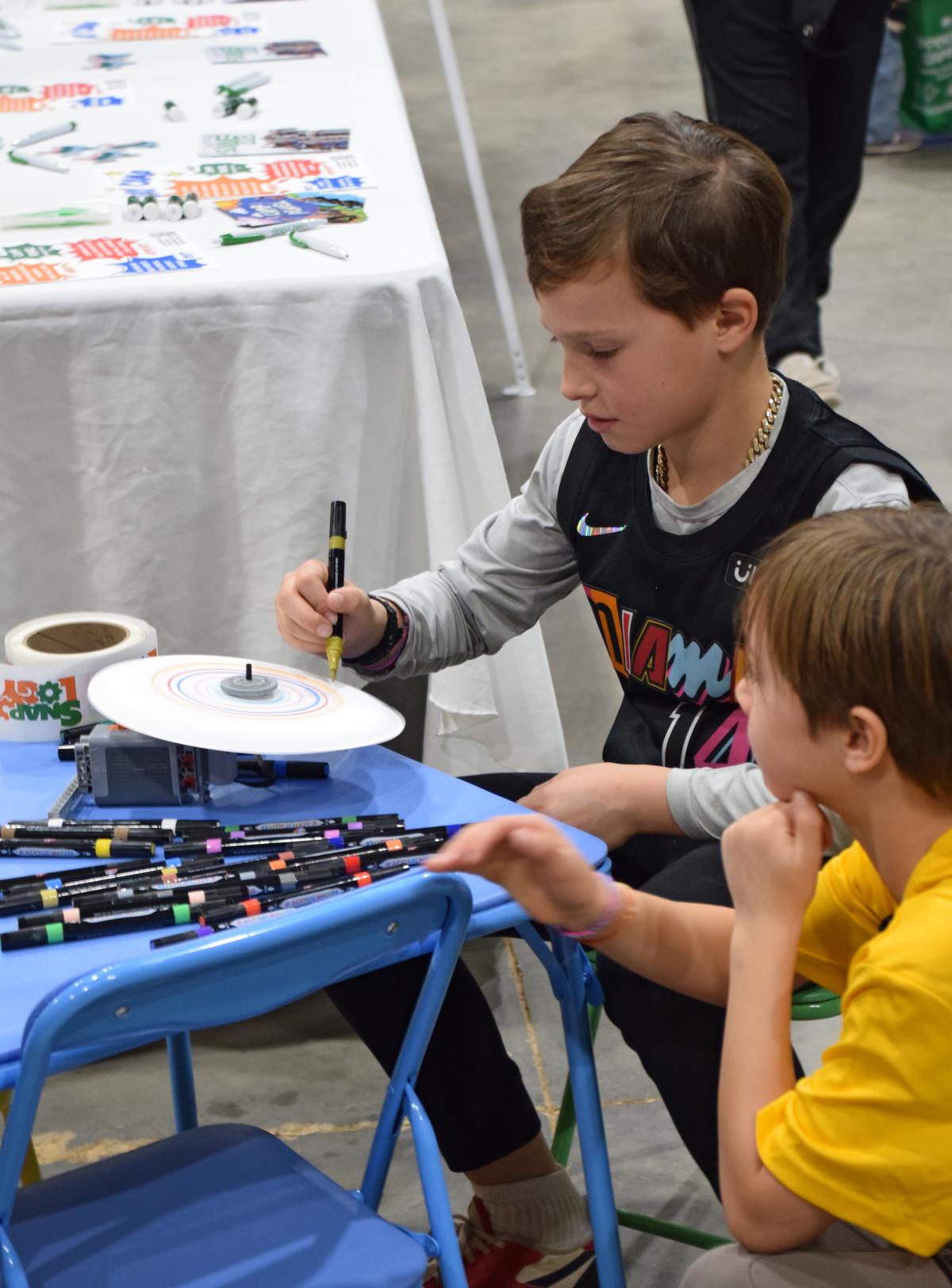 PHOTO BY LAURIE ANDERSON Kids try out an activity at the Snapology table.