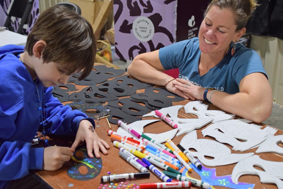 PHOTO BY LAURIE ANDERSON A visitor designs a mask at the booth for the Inspir...