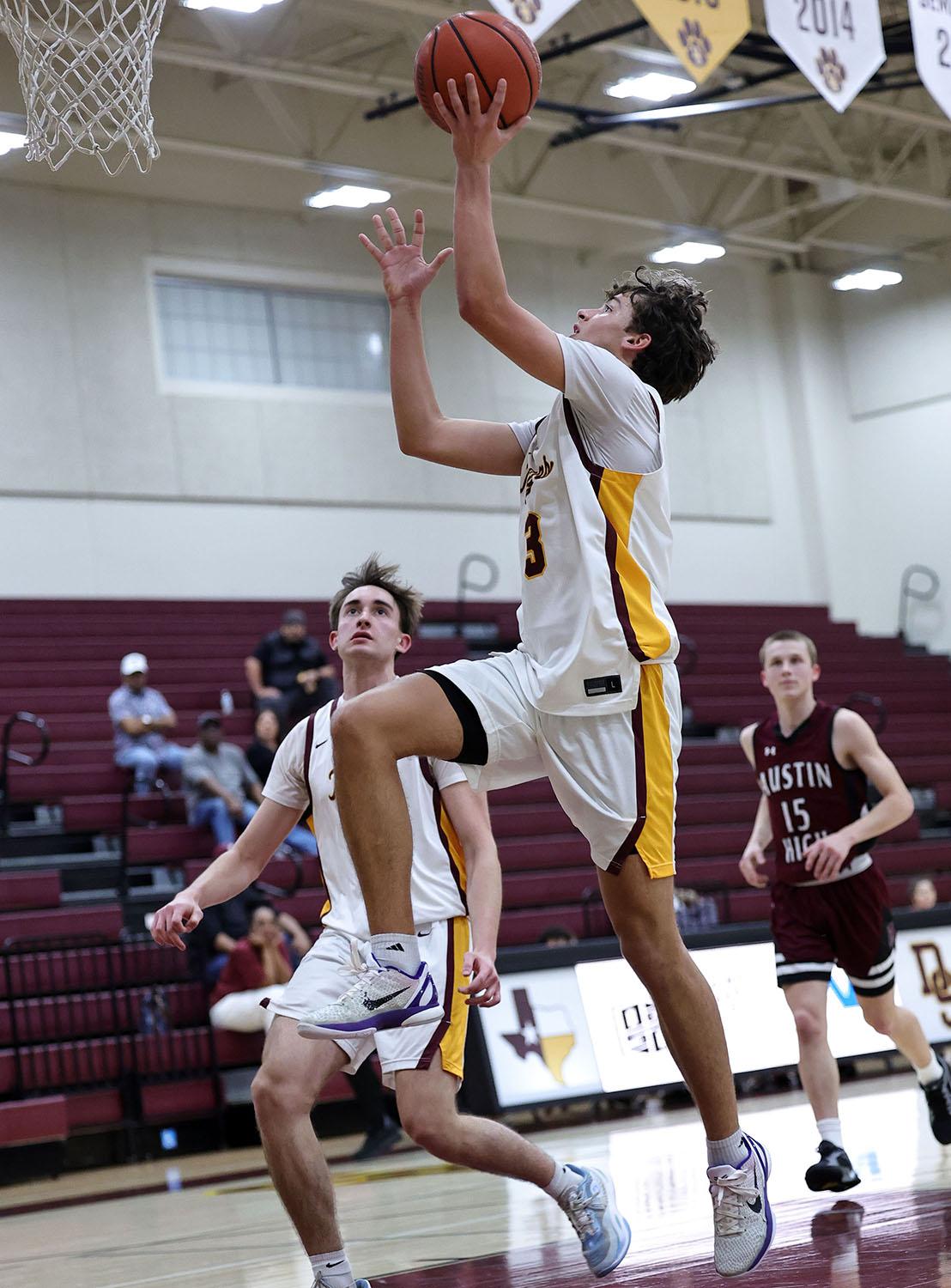 PHOTO BY VINCE CURLETTA Grant Reagan (#3) finishes his layup in Tuesday's gam...