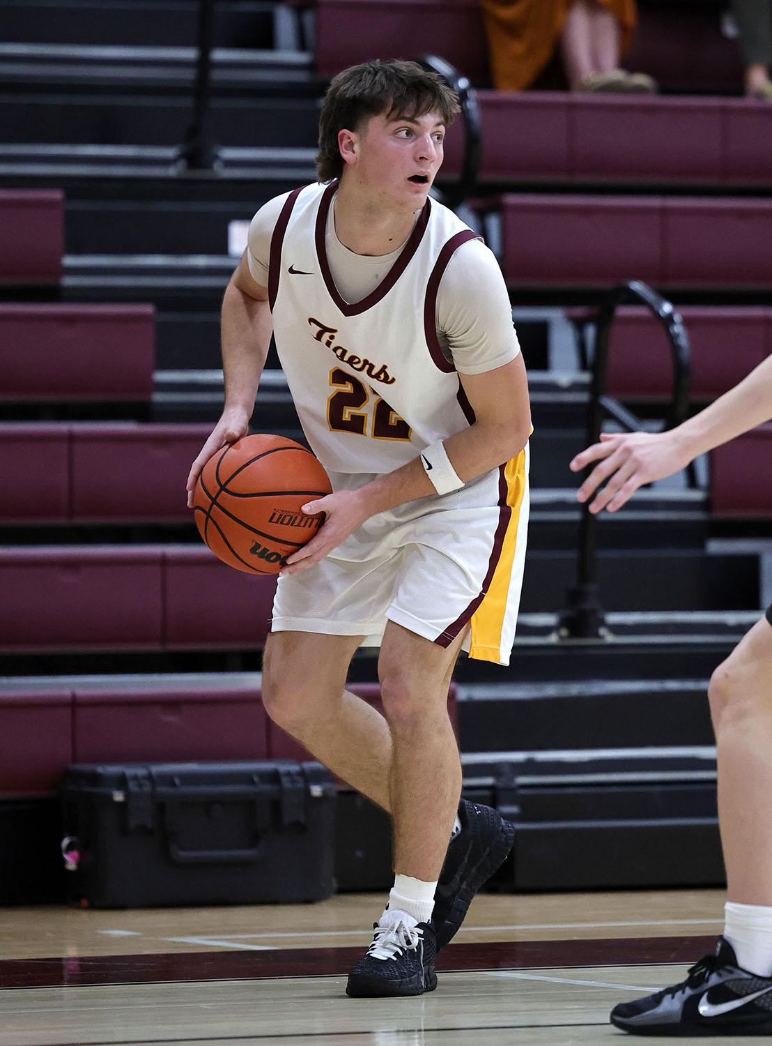 PHOTO BY VINCE CURLETTA Liam Lawson (#22) looks for someone to pass to in Tue...