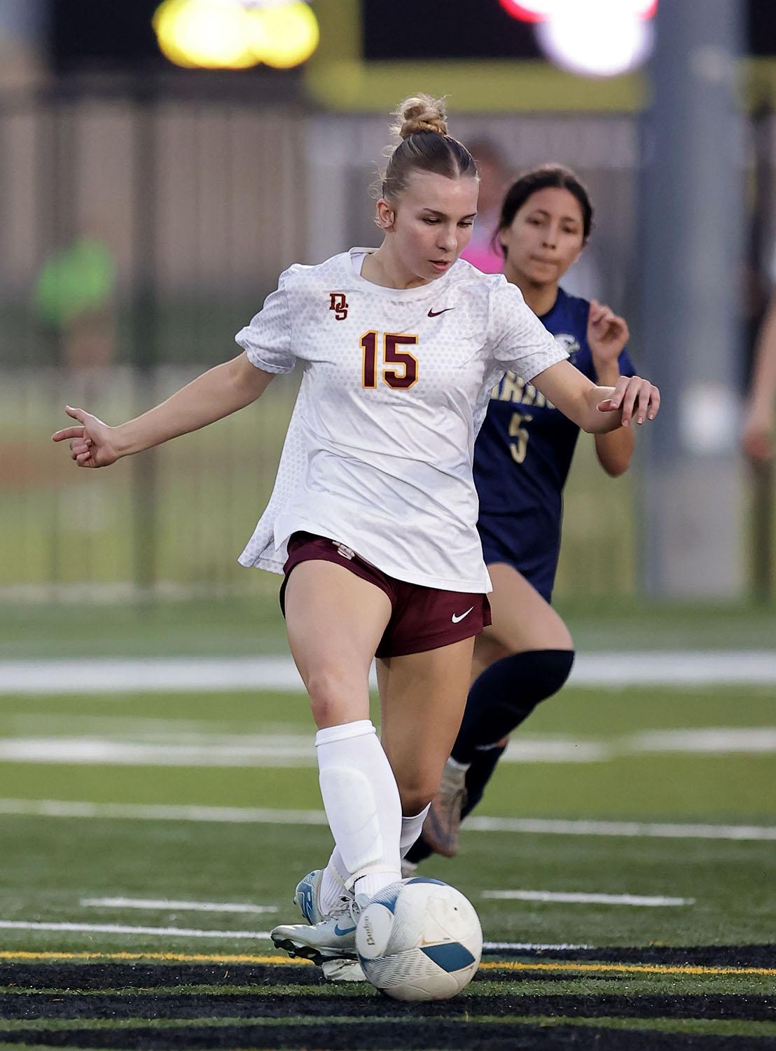 Vince Curletta Ella Castillo (#15) moves ahead of her Akins opponent.