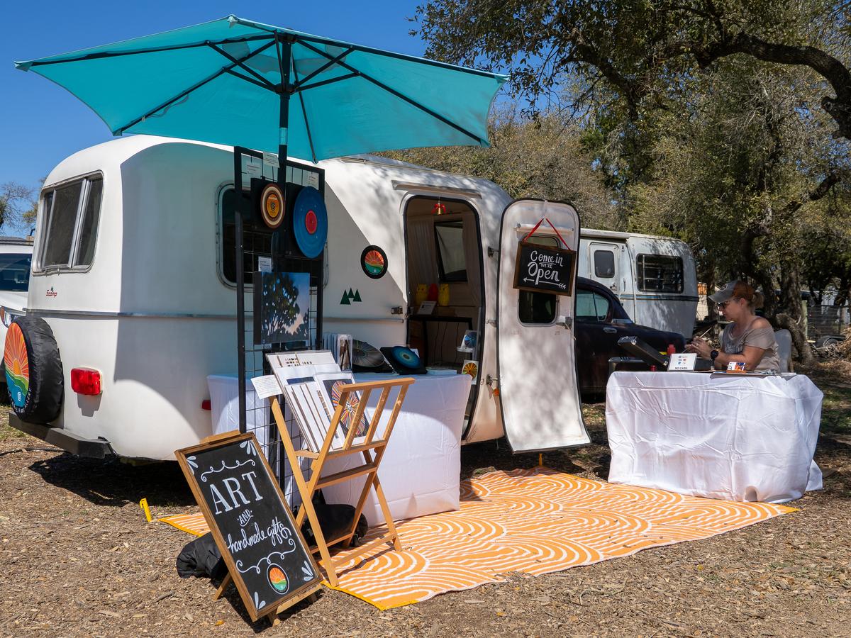 PHOTO BY DAVE WILSON Jennifer Swannack works on her art outside the Tiny Camp...