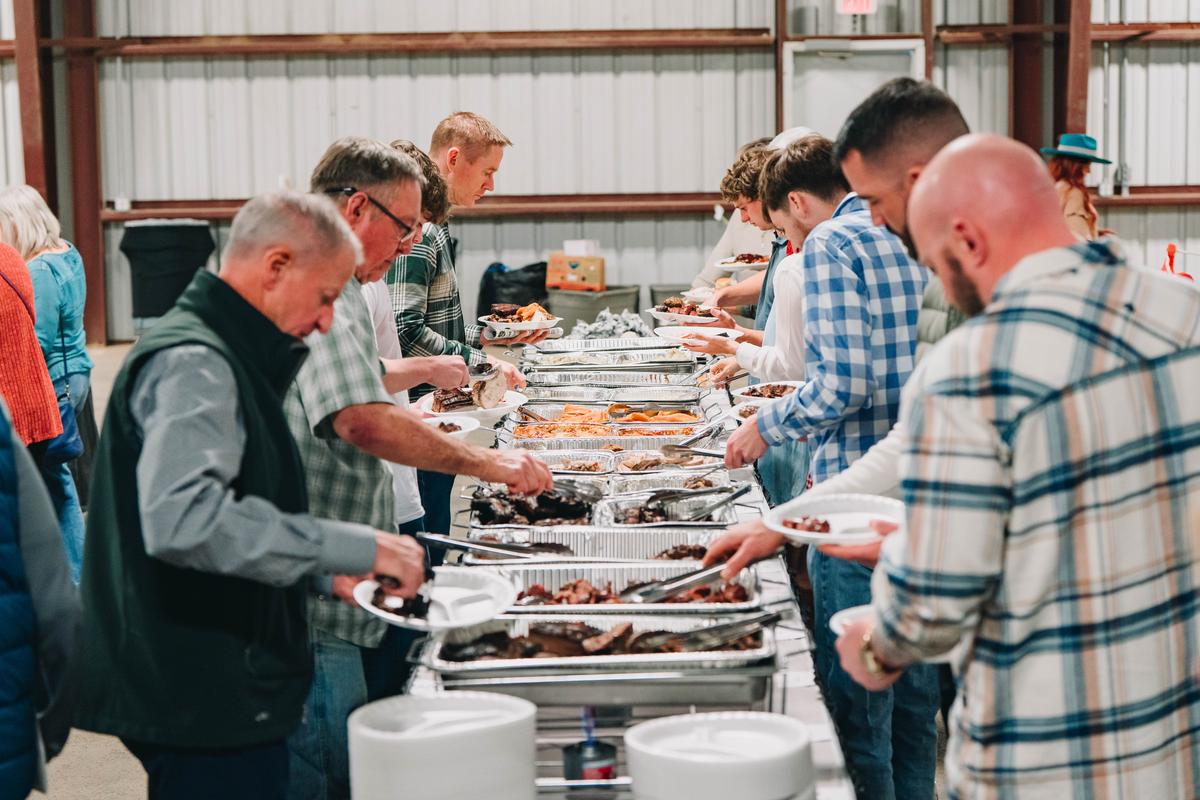 PHOTO COURTESY OF KATHERINE DRYE Attendees at the dinner go through the servi...