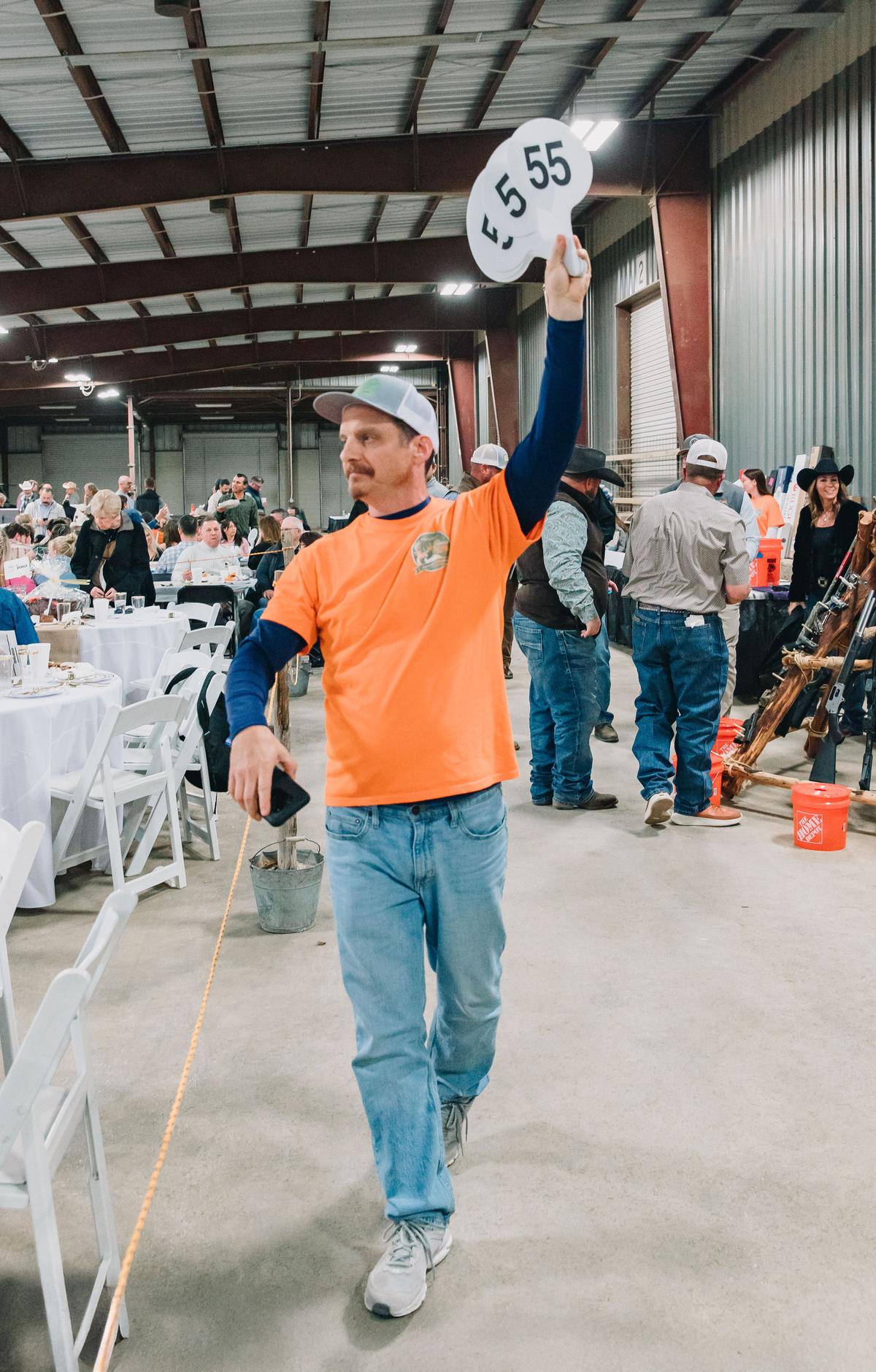 PHOTO COURTESY OF KATHERINE DRYE Prior to the auction, Rob Linton makes sure...