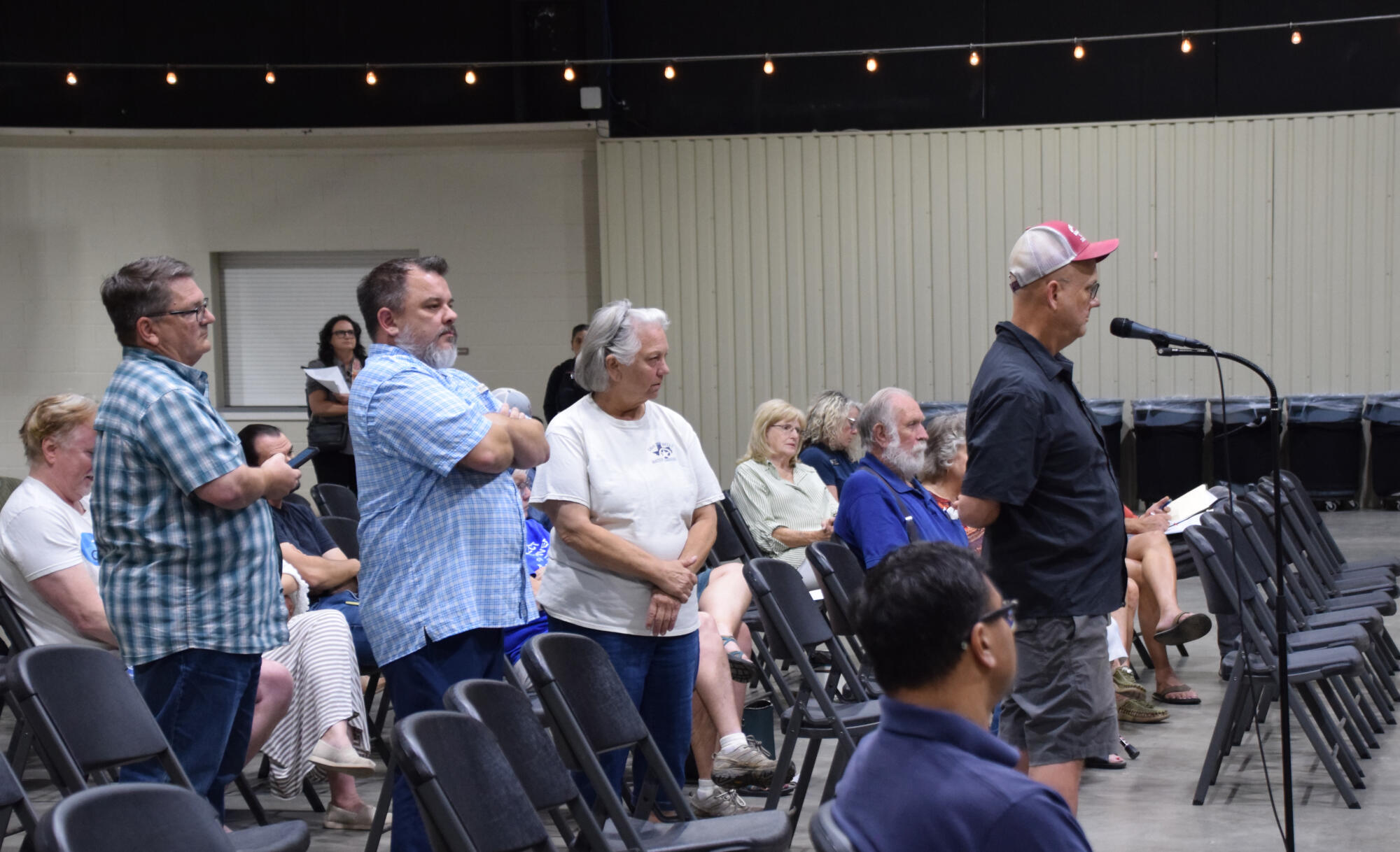 PHOTO BY LAURIE ANDERSON Concerned residents wait their turn to ask questions...