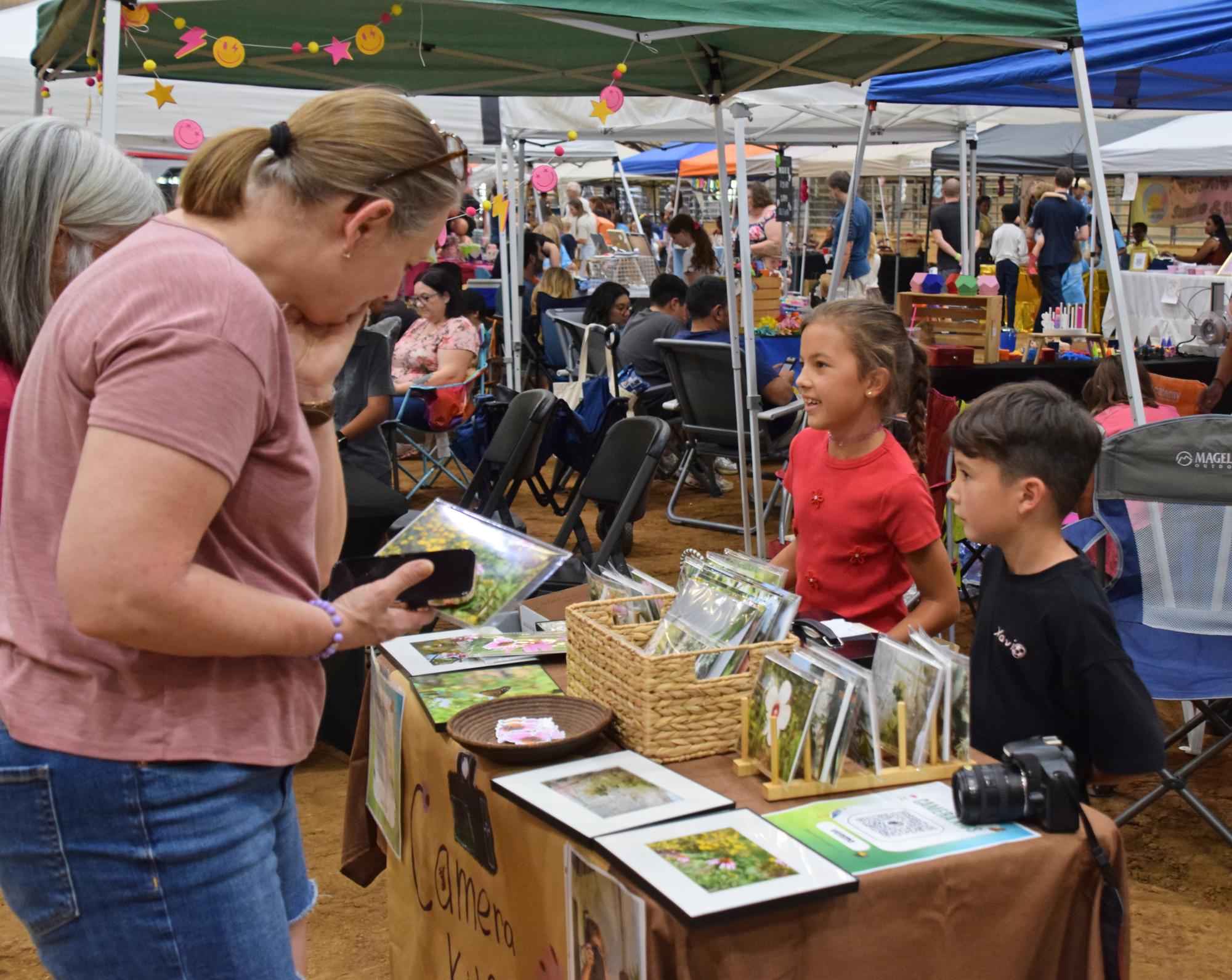 PHOTO BY LAURIE ANDERSON The Camera Kids sell their photography during the ma...