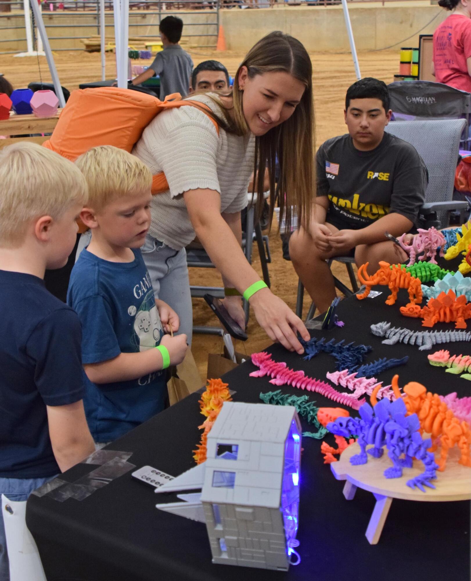 Customers look at Christopher Machado’s 3-D creations.
