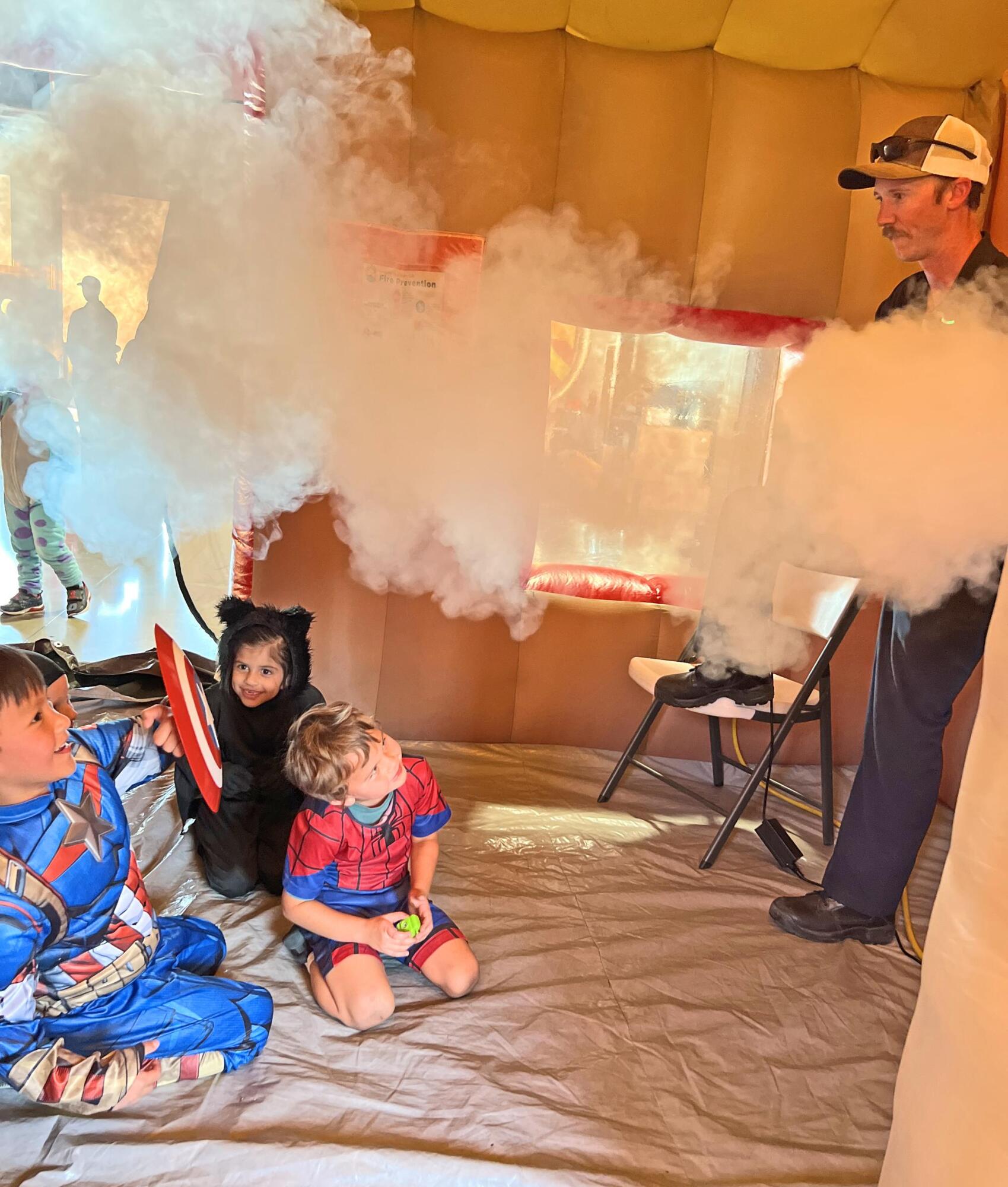 PHOTO BY LAURIE ANDERSON Kids get ready to crawl to safety during a demonstra...