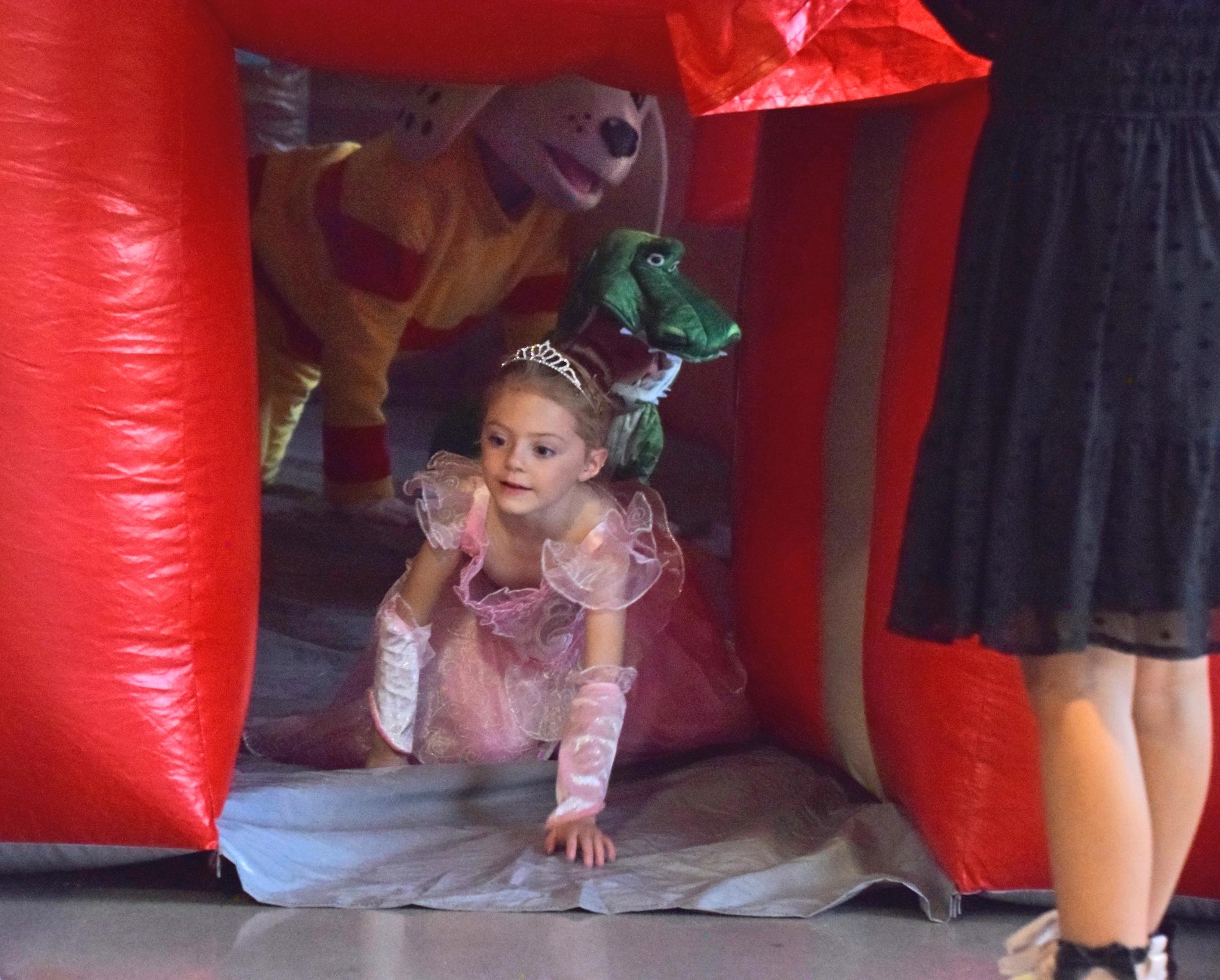 PHOTO BY LAURIE ANDERSON A princess, a dinosaur and Sparky the Fire Dog exit...