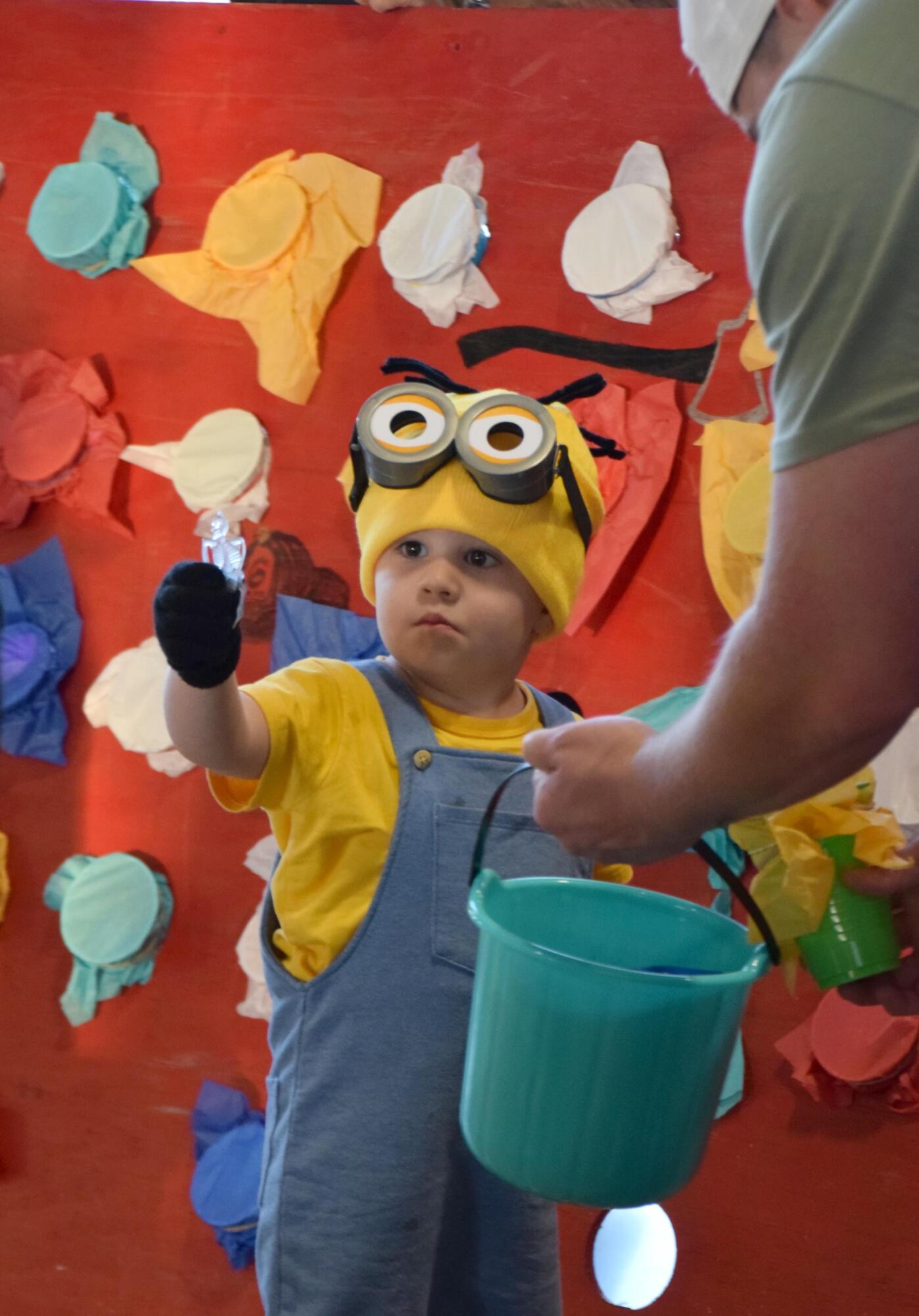 Dressed in his Minion costume, Beaux examines his prize skeleton.