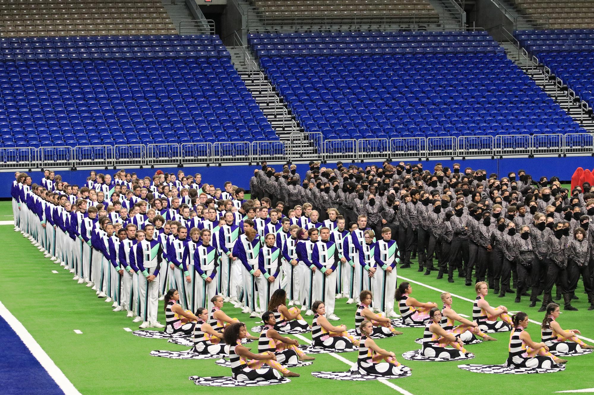 The Drippings Springs Tiger Band stand in full retreat at the Alamodome await...