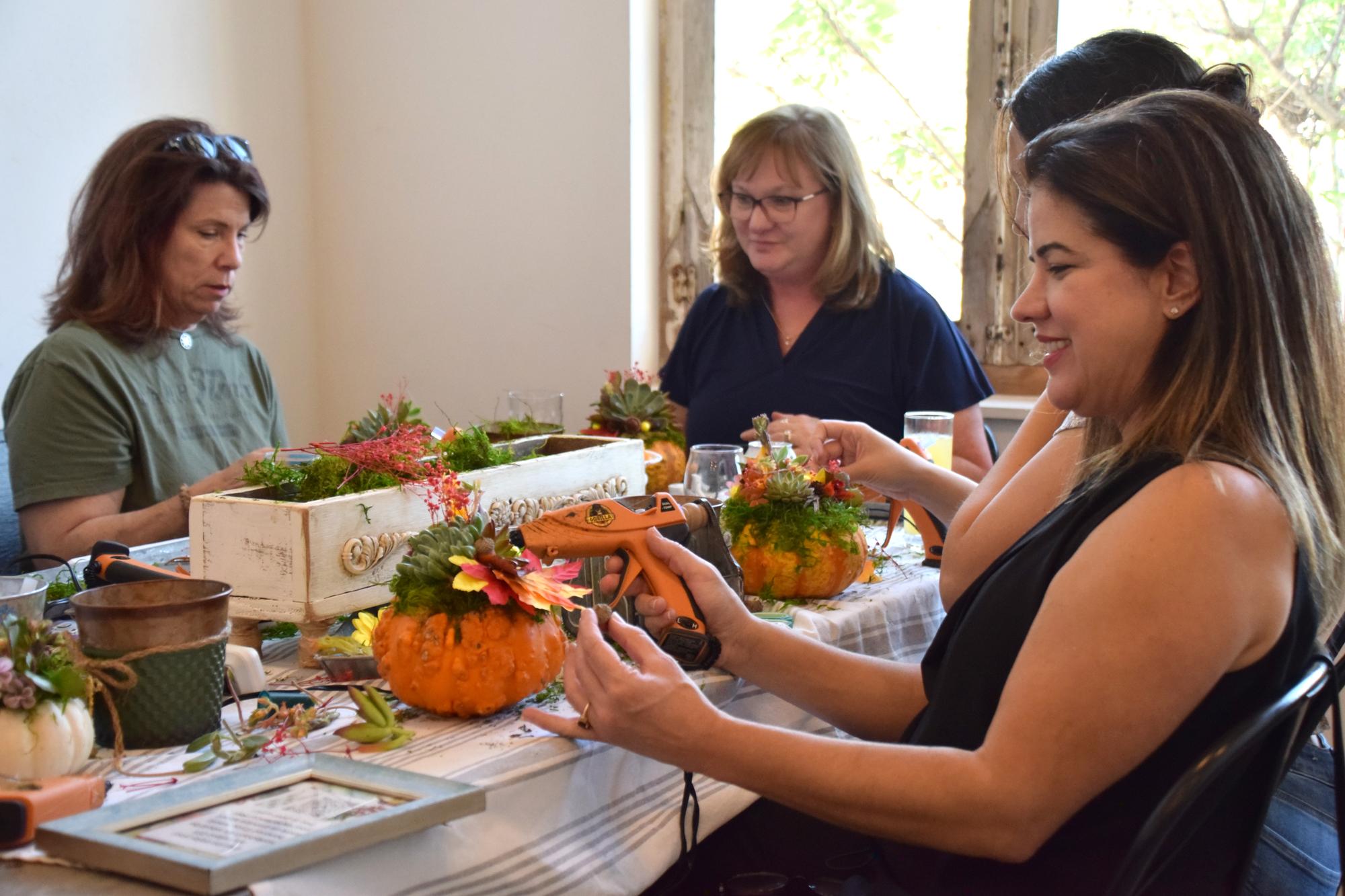 PHOTO BY LAURIE ANDERSON Participants in the fall workshop decorate their pla...