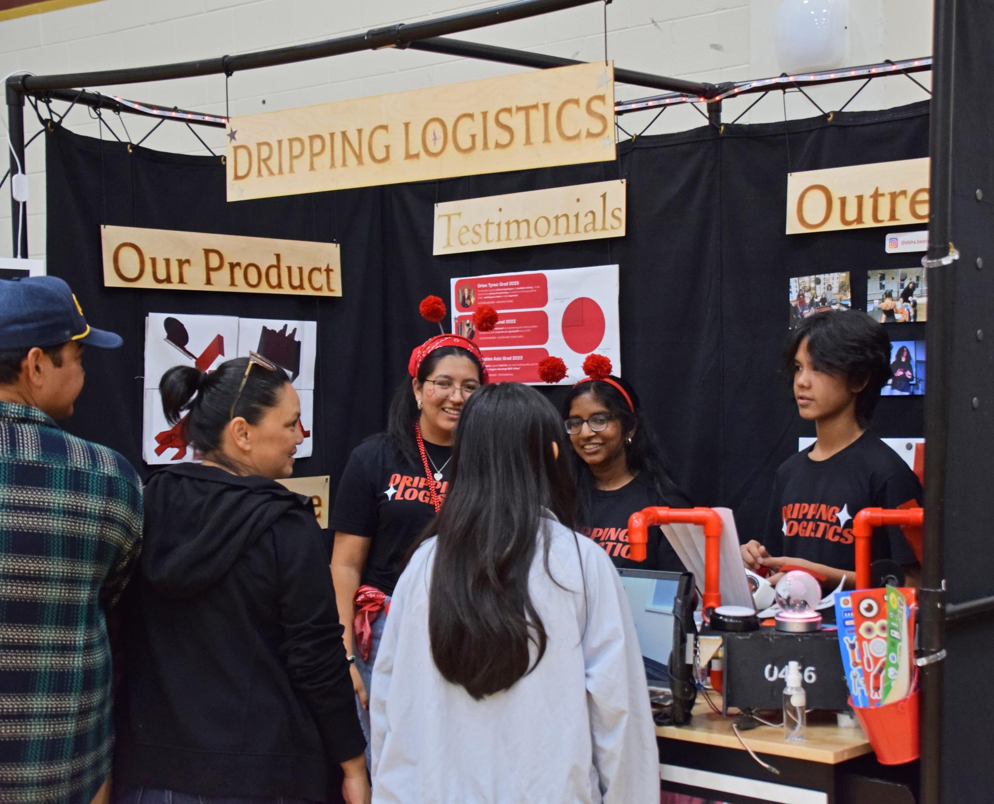 PHOTO BY LAURIE ANDERSON Business team members talk to visitors about their p...