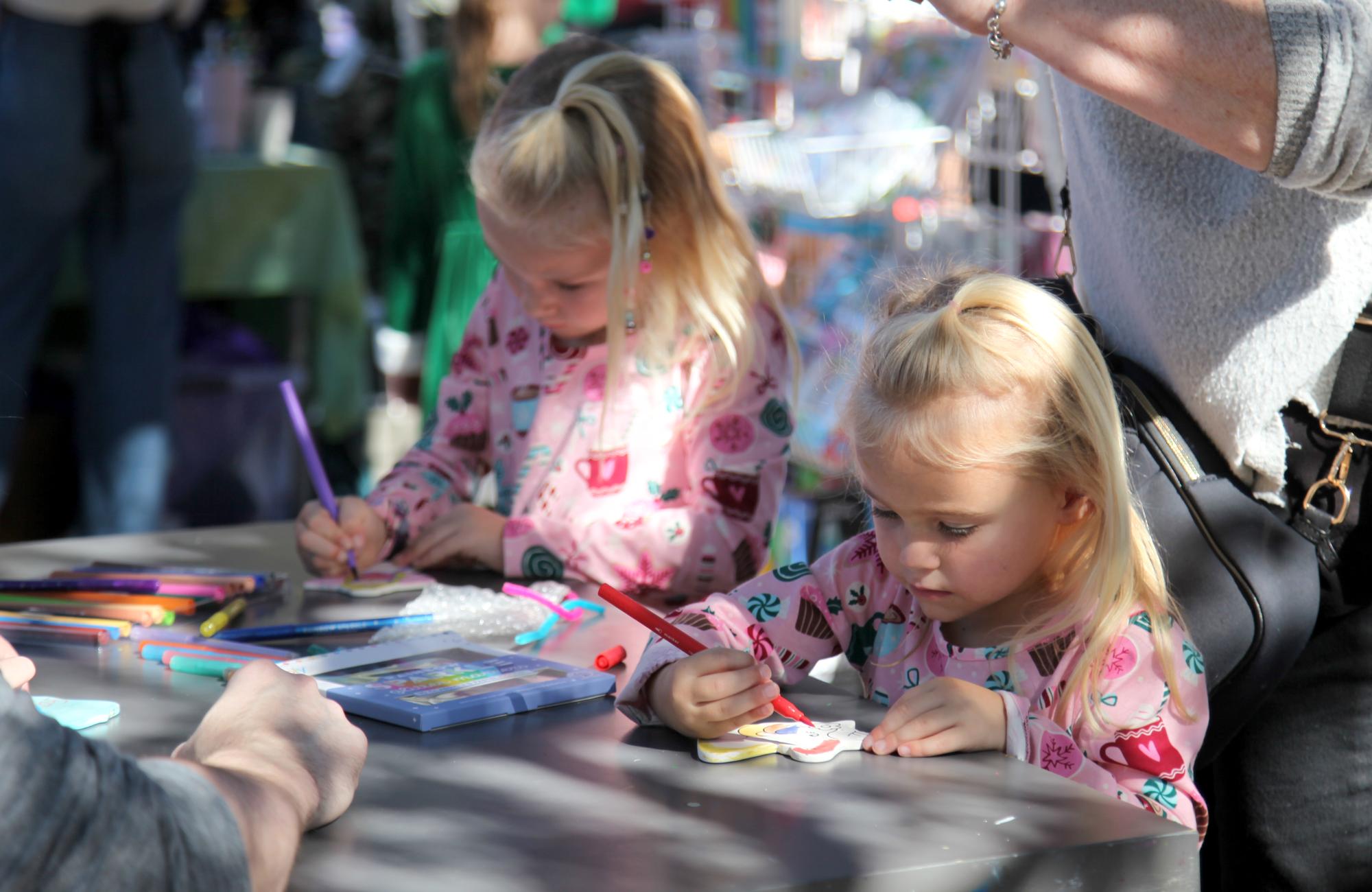 PHOTO BY LAURIE ANDERSON Kids decorate ornaments at one of the booths.