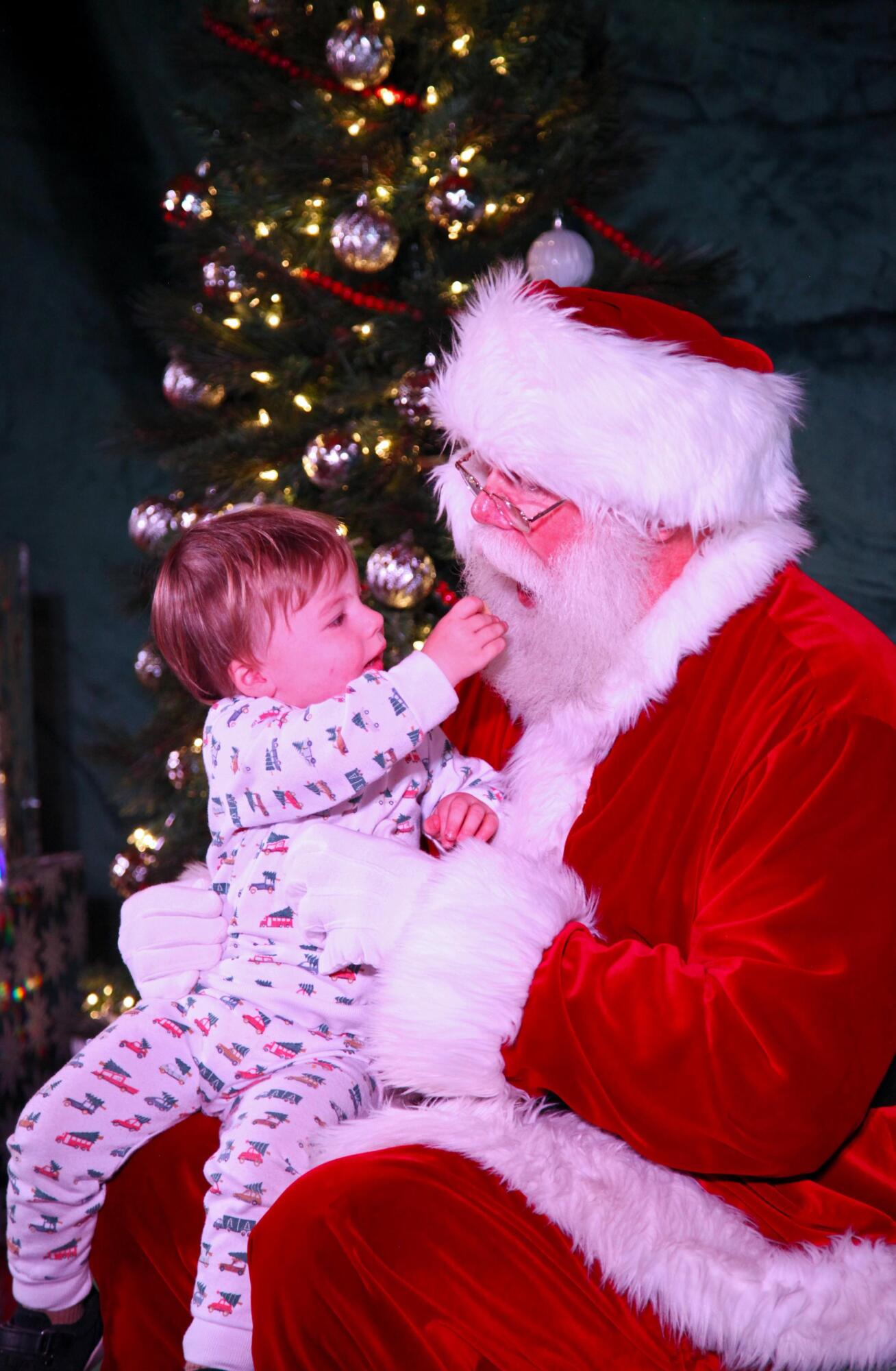 PHOTO BY LAURIE ANDERSON Danny Rankin shares a cookie with Santa. He initiall...