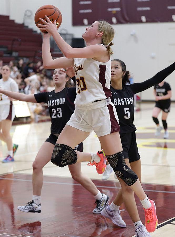 PHOTO BY VINCE CURLETTA Lily Aleshire (#20) goes for the layup Dec. 9 against...