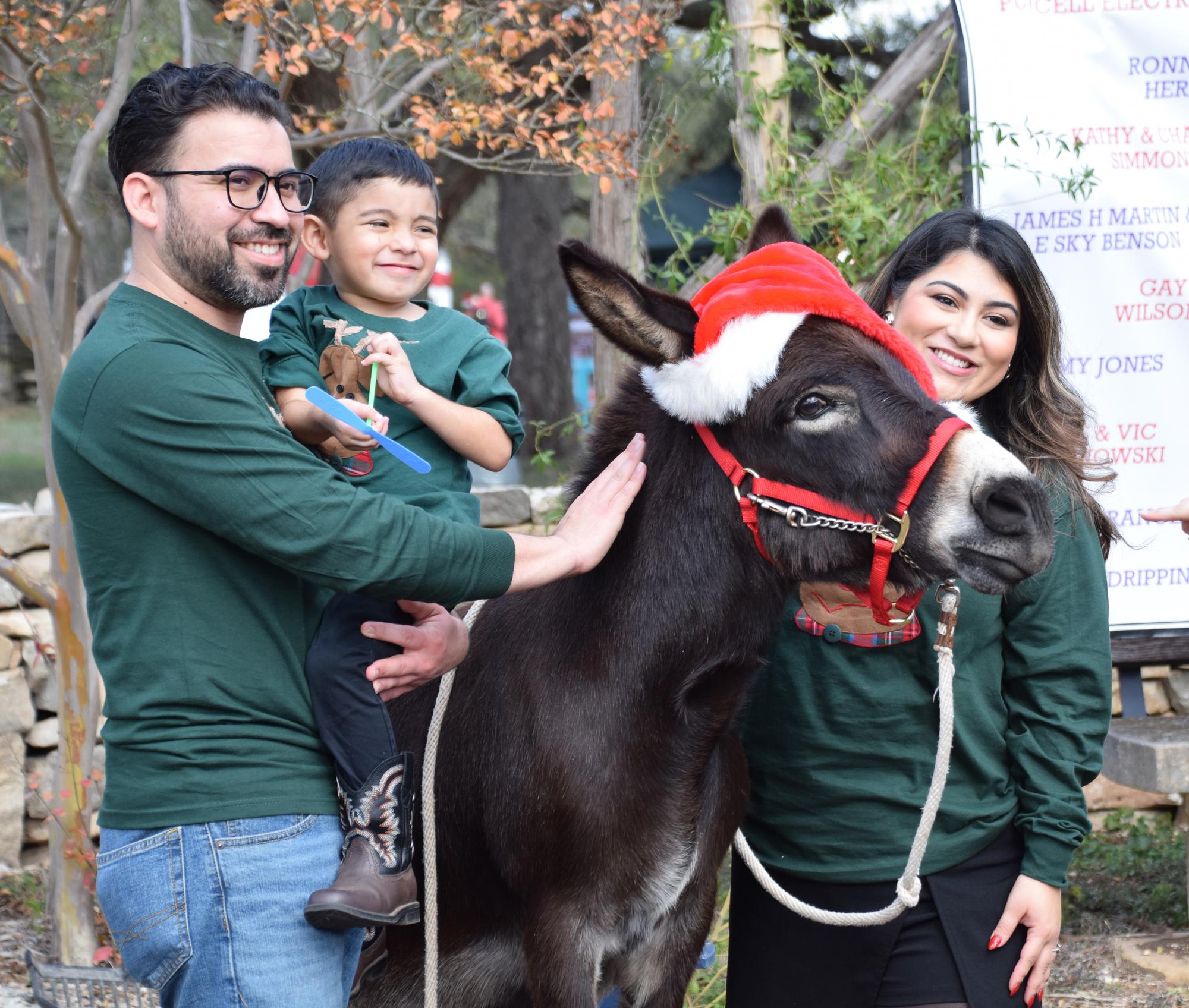 PHOTO BY LAURIE ANDERSON A family poses for a Christmas photo with a special...