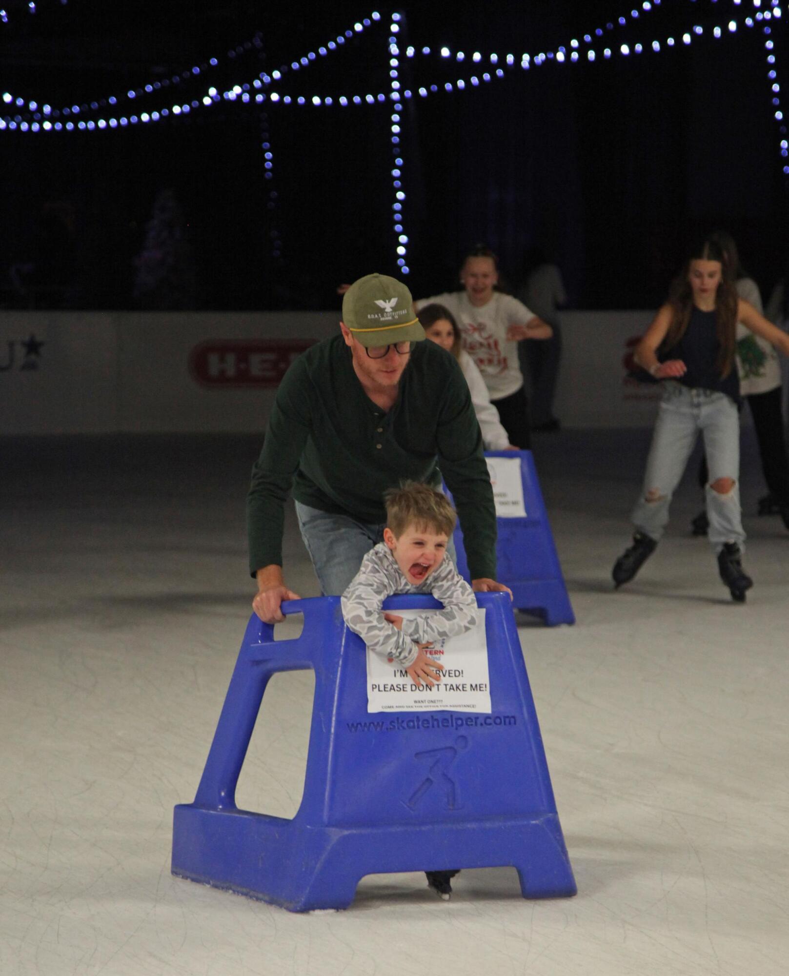 PHOTO BY LAURIE ANDERSON One of the younger patrons gets a push in the skate...