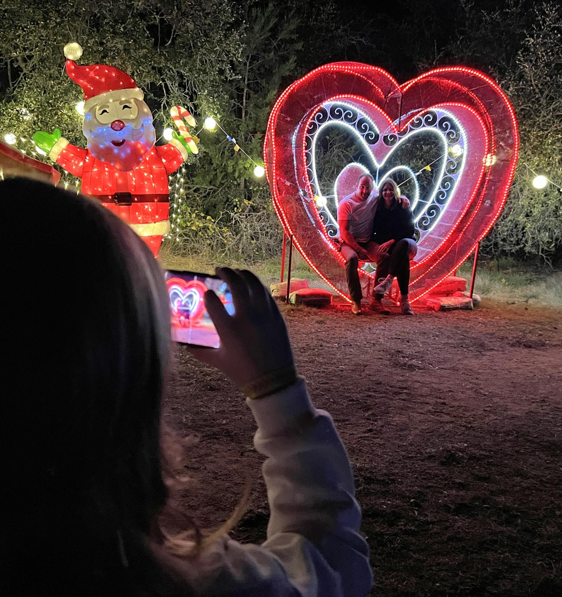PHOTO BY LAURIE ANDERSON A young child takes a photo of her parents on the Tr...